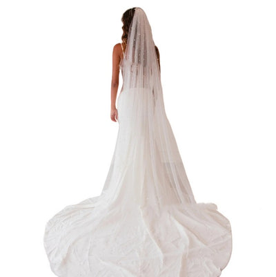 Mid-length white bridal veil with scattered pearl embellishments, flowing elegantly on a mannequin. - Image 10