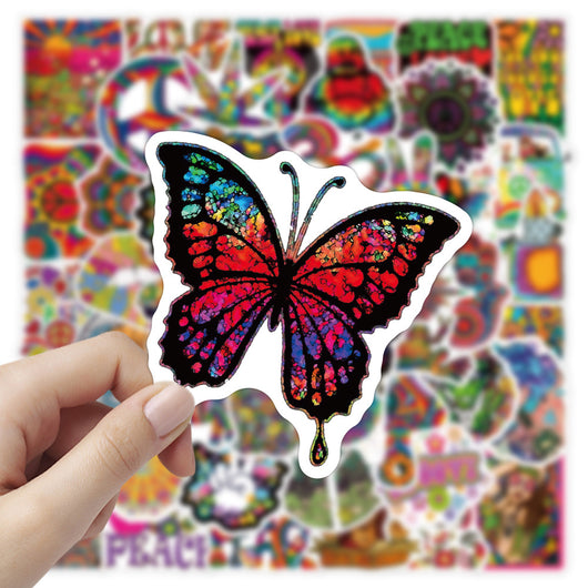 A hand holds a vibrant, tie-dye butterfly sticker with a black outline, against a blurred background of many other colorful, hippie-style stickers. - Image 8