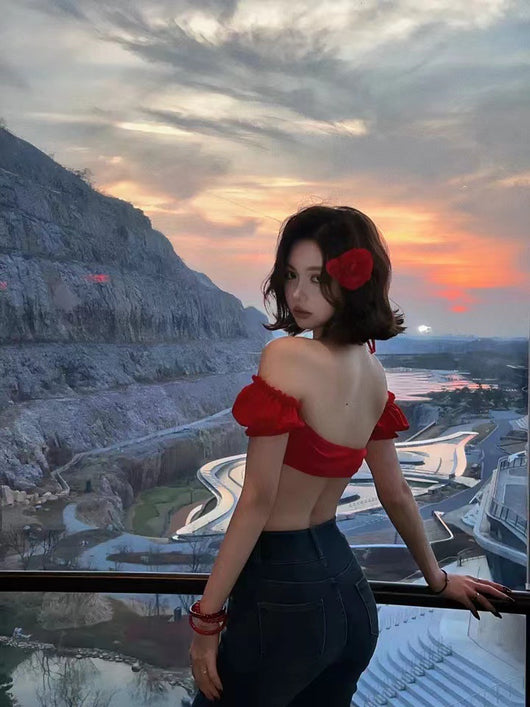 Woman in a red strapless ruffled bikini top and matching sarong on a beach at sunset. - Image 9