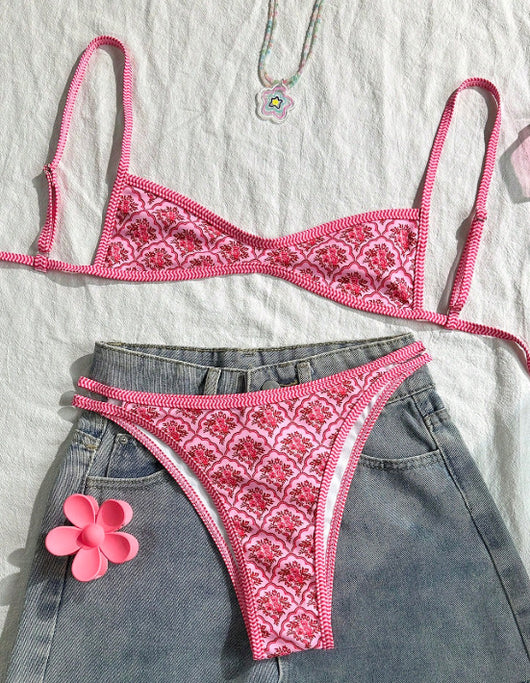 Pink two-piece bikini with a red floral and geometric print, featuring a bandeau top and high-cut bottoms. - Image 2