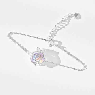 Gold-tone necklace with an iridescent camellia flower pendant and small clear stones on a delicate chain. - Image 8