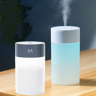 M Style mini humidifier with a light blue top and translucent white body, suitable for bedroom or office.