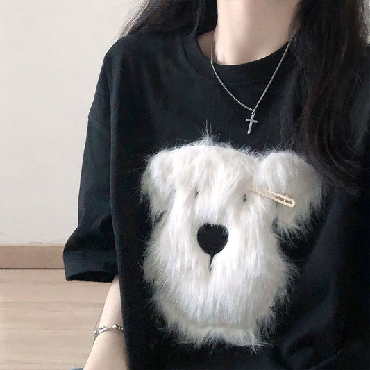 Black short sleeve t-shirt with a fluffy white puppy face embroidery, featuring a small gold barrette on its ear. - Image 2