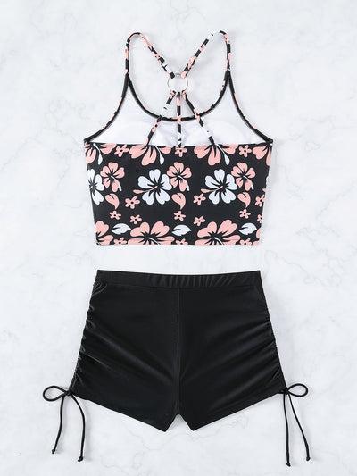 Women's two-piece swimsuit featuring a black halter crop top with pink and white floral print and solid black swim shorts. - Image 9