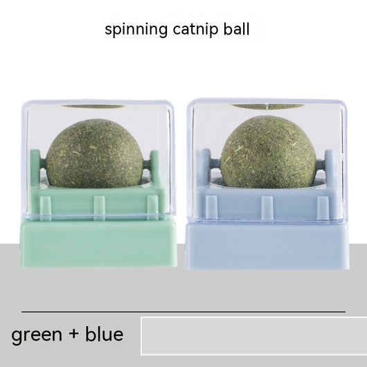 Two spinning catnip balls, one with a green base and one with a blue base, in clear plastic cases. - Image 6