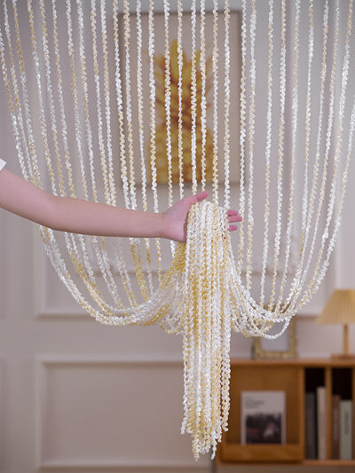 Brown and beige striped string curtain with twisted tassel texture, held by a hand, for living room partition. - Image 12