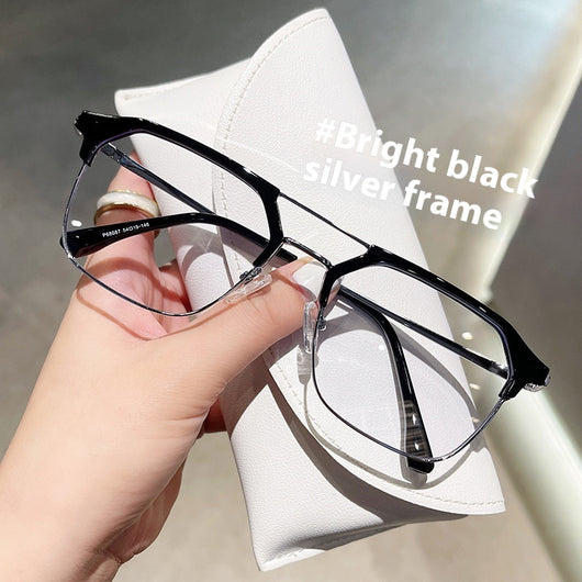 Anti-blue light glasses with a sand black and silver double beam frame, held against a white case. - Image 7