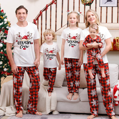 Family of five wearing matching Christmas pajamas with white 'Cousin Crew' tops and red plaid snowflake pants. - Image 2