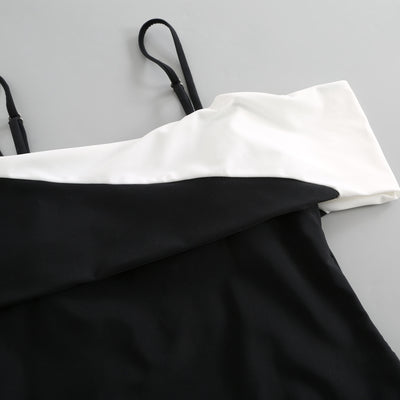 Black one-piece swimsuit with a deep V-neckline and white horizontal stitching detail across the plunge. - Image 30