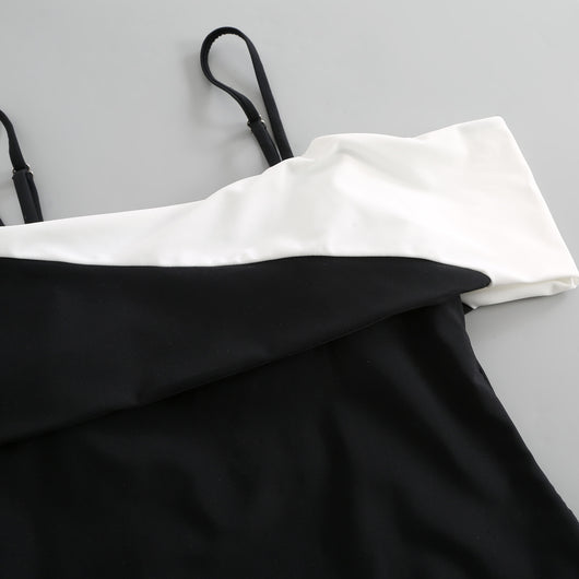 Black one-piece swimsuit with a deep V-neckline and white horizontal stitching detail across the plunge. - Image 30