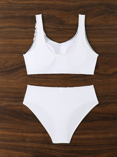 Women's two-piece swimsuit with black and purple floral print. Features a V-neck sports bra top and mid-rise bottom. - Image 30