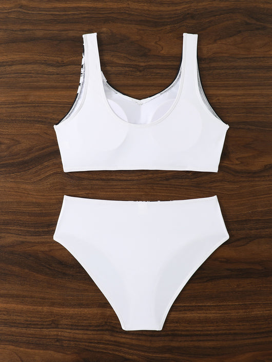Women's two-piece swimsuit with black and purple floral print. Features a V-neck sports bra top and mid-rise bottom. - Image 30