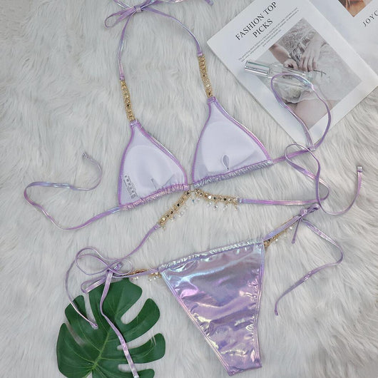 Iridescent purple and pink two-piece bikini with gold-toned crystal embellishments on a white faux fur background. - Image 37