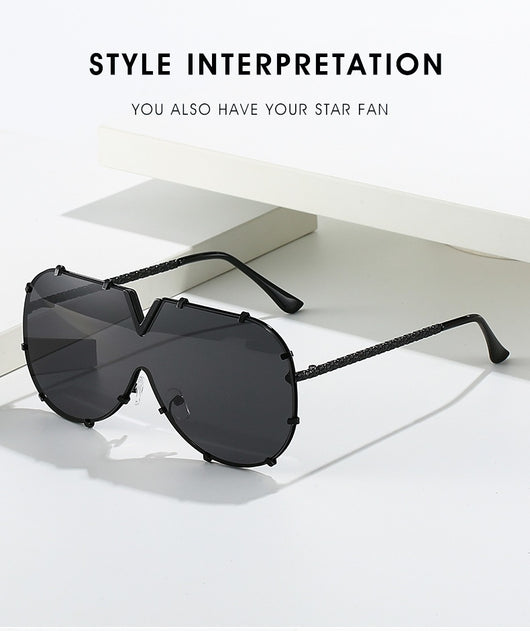 Oversized V-shaped sunglasses with a gold metal frame, white accents, clear lenses, and decorative rivets. - Image 20