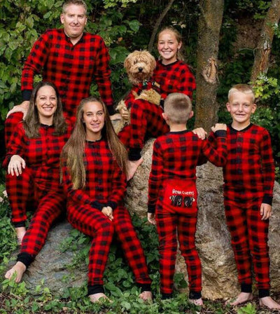 Red and black buffalo plaid baby romper with long sleeves, snap front closure, and black ribbed cuffs and collar.