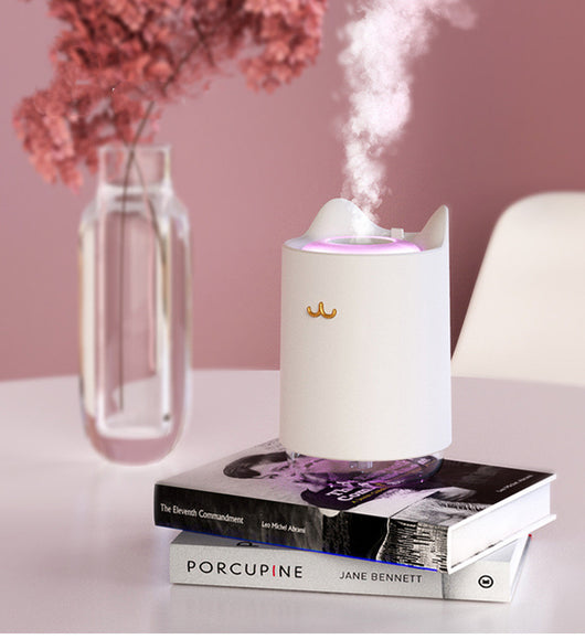 White mini USB humidifier with cat ears and a gold cat nose/mouth emblem, featuring a clear water tank base. - Image 9