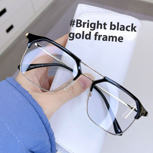 Anti-blue light glasses with a sand black and silver double beam frame, held against a white case. - Image 11