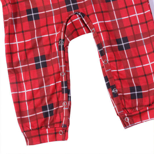 Family of four and their dog wearing matching red and black plaid Christmas pajamas, smiling against a white background. - Image 15