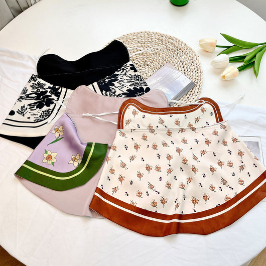 Female cream and black floral polka dot sun protection mask with ear loops, designed for eye corner protection. - Image 41