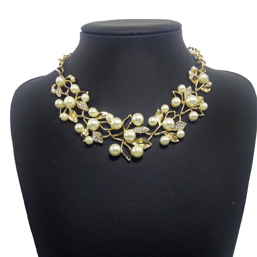 Gold-toned necklace and matching earrings set with faux pearls and clear rhinestones in an elegant leaf and vine design. - Image 6