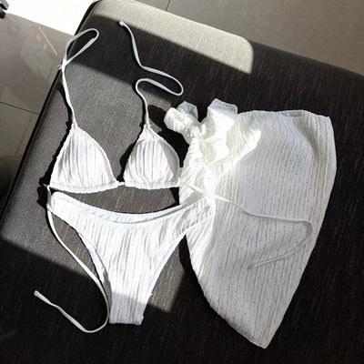 White textured bikini with ruched triangle top, high-cut bottom, and matching sarong with a large bow. - Image 9