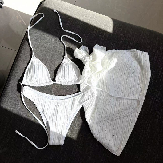 White textured bikini with ruched triangle top, high-cut bottom, and matching sarong with a large bow. - Image 9