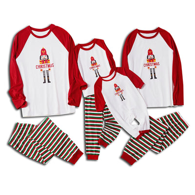 Matching family Christmas pajamas with white raglan tops, red sleeves, and a nutcracker graphic, paired with red, green, and white striped pants. Includes adult - Image 6