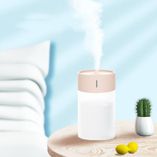 Cylindrical humidifier with a frosted white body and a light pink top, featuring a small mist outlet. - Image 8
