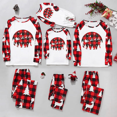 Matching family Christmas pajamas in red and black plaid with "Merry Christmas" text, tree, and reindeer prints. - Image 3