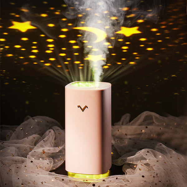 Light blue aromatherapy machine and projection humidifier with a gold 'V' logo and translucent base.