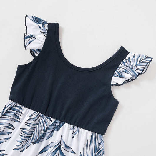 Young boy wearing a white short-sleeve t-shirt with blue tropical leaf print and a black chest pocket. - Image 25