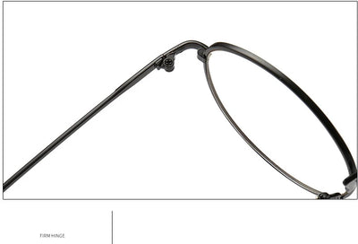 Black round anti-blue light glasses with clear lenses showing a blue reflection, resting on a gray textured surface. - Image 14