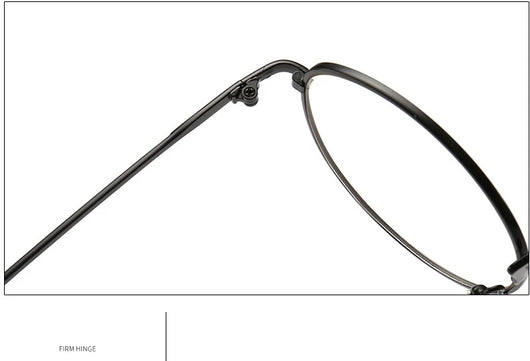 Black round anti-blue light glasses with clear lenses showing a blue reflection, resting on a gray textured surface. - Image 14