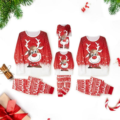 Family of four wearing matching red Christmas pajamas with reindeer and snowflake patterns and red pom-pom beanies. - Image 10