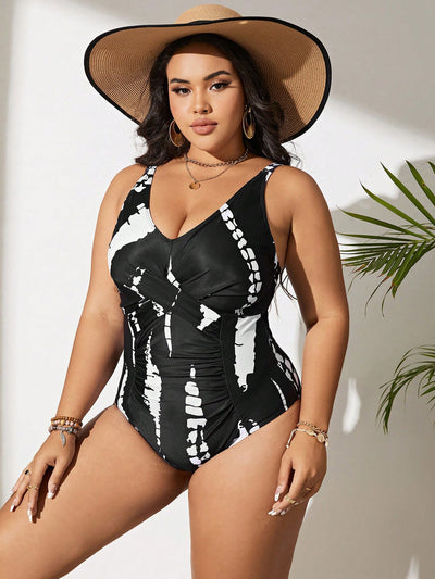 Plus size black and white tie-dye one-piece swimsuit with a V-neck and ruched detailing, worn by a model. - Image 6