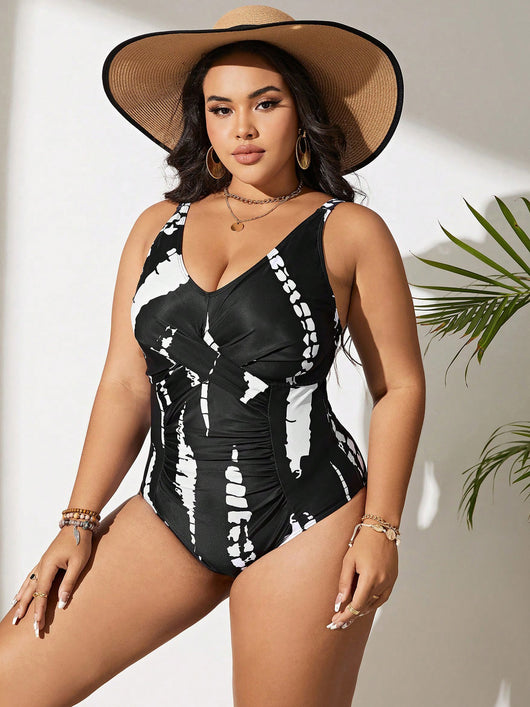 Plus size black and white tie-dye one-piece swimsuit with a V-neck and ruched detailing, worn by a model. - Image 6