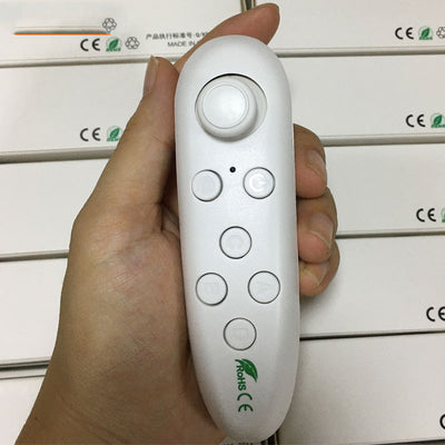 White Bluetooth remote control gamepad with joystick and multiple buttons, held in a hand.