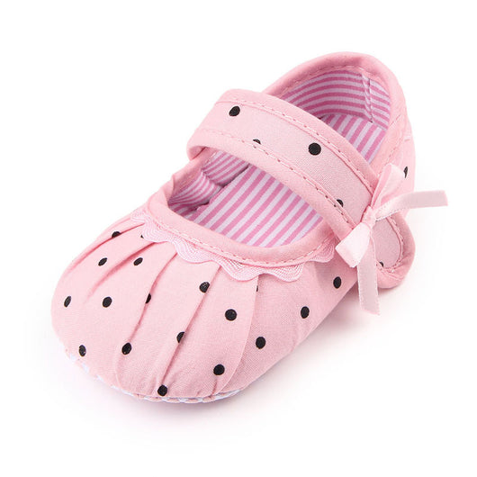 Black baby girl Mary Jane shoes with white polka dots, a strap, bow accent, and striped lining. - Image 3