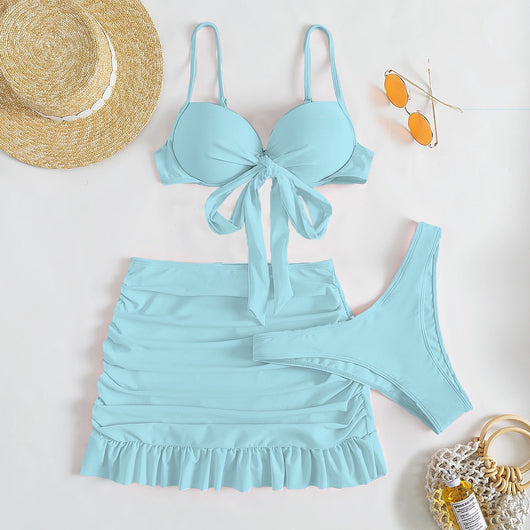Light blue three-piece women's swimsuit with a bow-front bikini top, ruched mini skirt, and matching bottoms. - Image 3