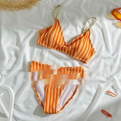 Orange and light orange striped bikini bottom with a ribbed texture and elastic waistband, ideal for beach vacations. - Image 3