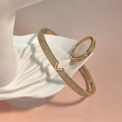 V-shaped 18K gold electroplated bracelet and ring set with pave clear stones on a white stand. - Image 8