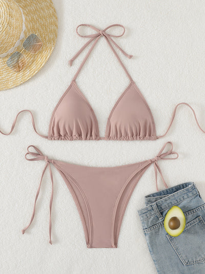 Neon yellow halter bikini with triangle top and tie-side bottoms, displayed on a light wood surface. - Image 41