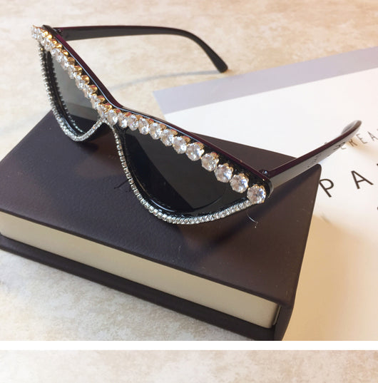 Two pairs of cat-eye sunglasses, one black with clear rhinestones and one pink with pink rhinestones, on a light surface. - Image 7