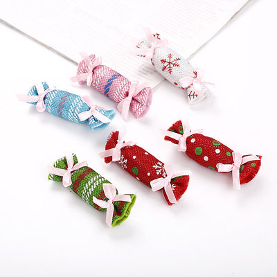 Six colorful fabric pet toys shaped like wrapped candies, featuring plaid, polka dot, and snowflake patterns. - Image 10