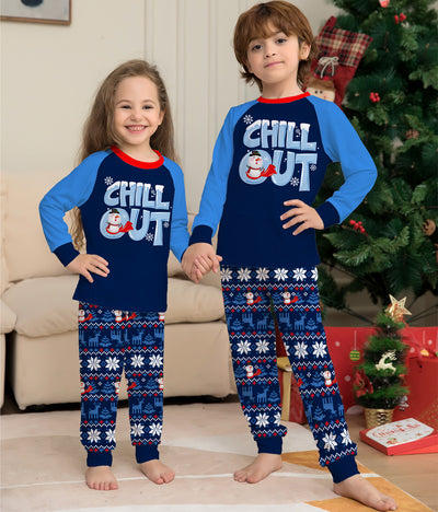 Family of four wearing matching blue and navy Christmas pajamas with 'CHILL OUT' snowman and snowflake patterns. - Image 11