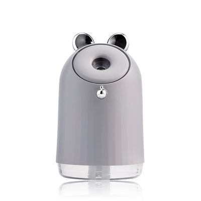 Grey humidifier table lamp with a clear base and decorative silver ears, featuring a mist outlet and control button. - Image 4
