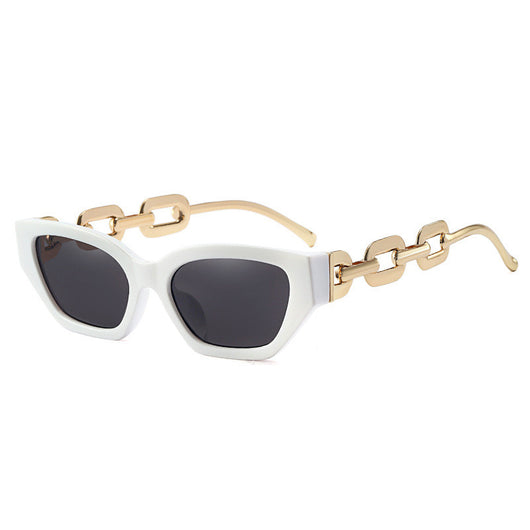 Red cat-eye sunglasses with dark lenses and gold-colored chain link temples on a white background. - Image 3