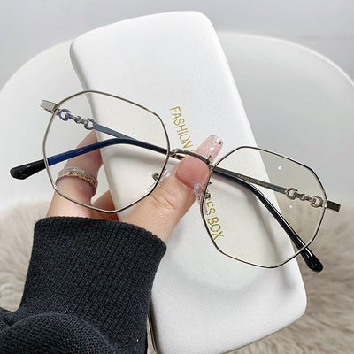 Rose gold frameless polygon anti-blue light glasses with clear lenses, held by a hand with pink nails. - Image 4