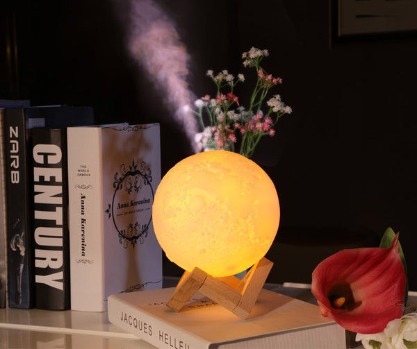 Moon-shaped night light and air humidifier on a wooden stand, emitting mist and a warm glow, with books and flowers. - Image 30