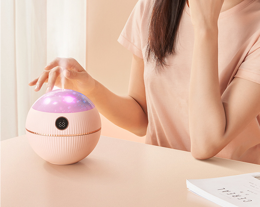 Pink spherical humidifier with a white top, ribbed texture, rose gold band, and a digital display showing 73%. - Image 10